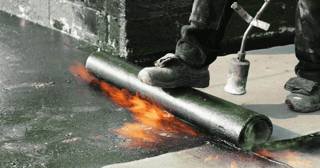 Applying waterproofing membrane on balcony surface in Pretoria complex.