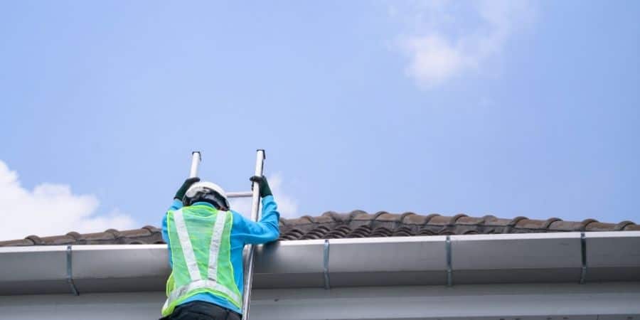 Roof inspection by a professional technician on a residential roof.